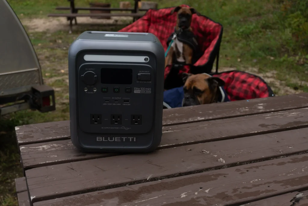 BLUETTI Elite 100 mini on a table with two dogs in the background